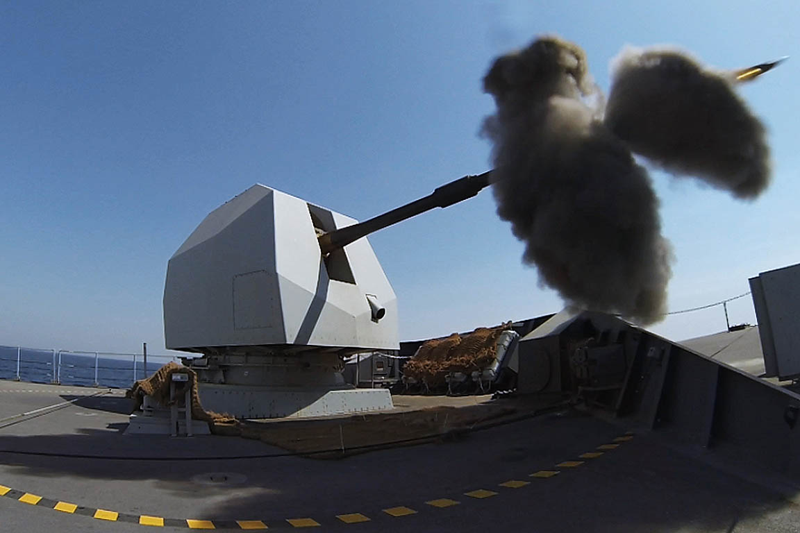 HMS DEFENDER fires her 4.5 inch Mk 8 Mod 1 naval gun